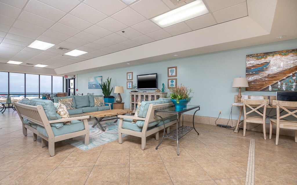 Relax in this inviting lounge with beach views, comfortable seating, and a cozy atmosphere perfect for unwinding