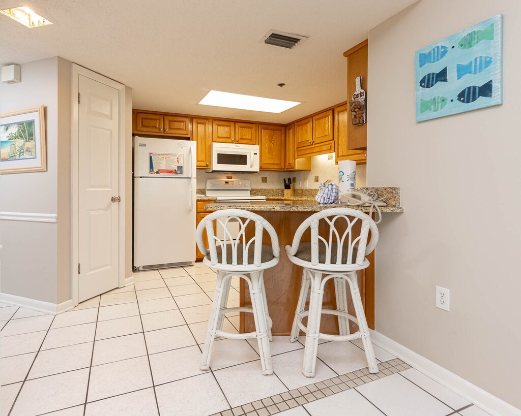 Gather around the breakfast bar with stylish seating, perfect for casual meals and conversations in the kitchen
