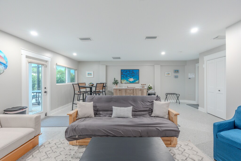 Unwind in your spacious living room where modern comfort meets coastal charm, featuring cozy seating and peaceful views.