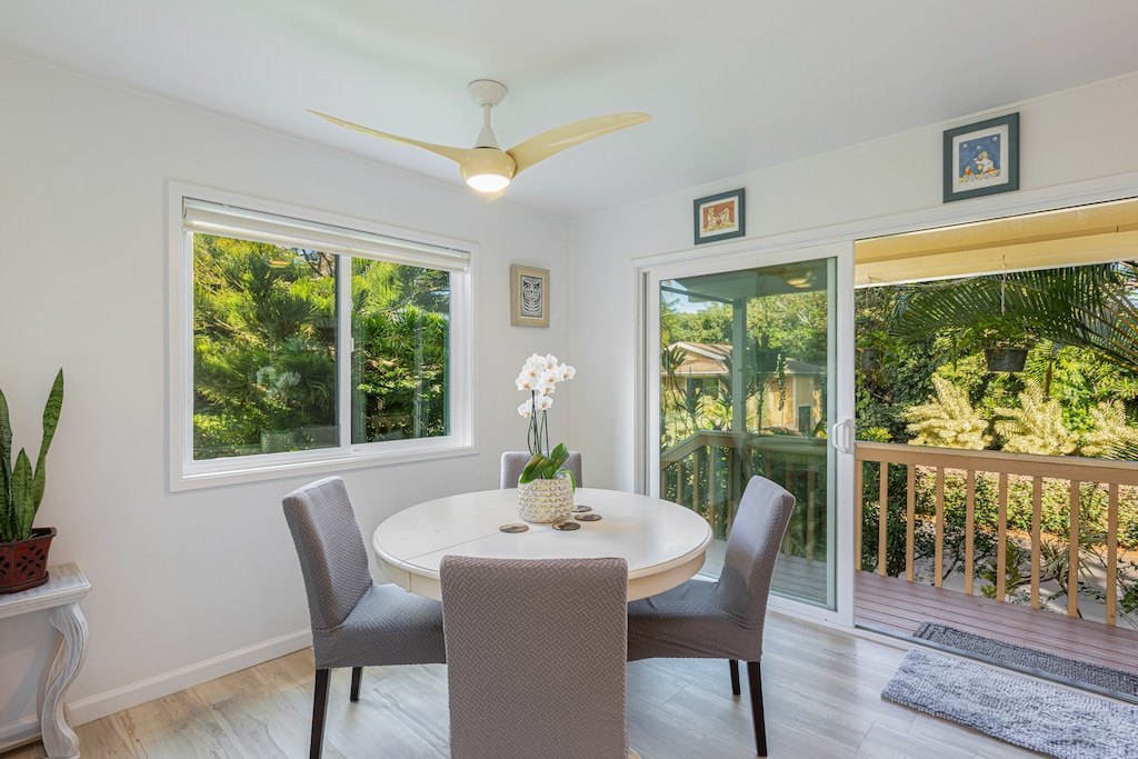 Casual dining area with tropical greenery views and sliding door access to the lanai.