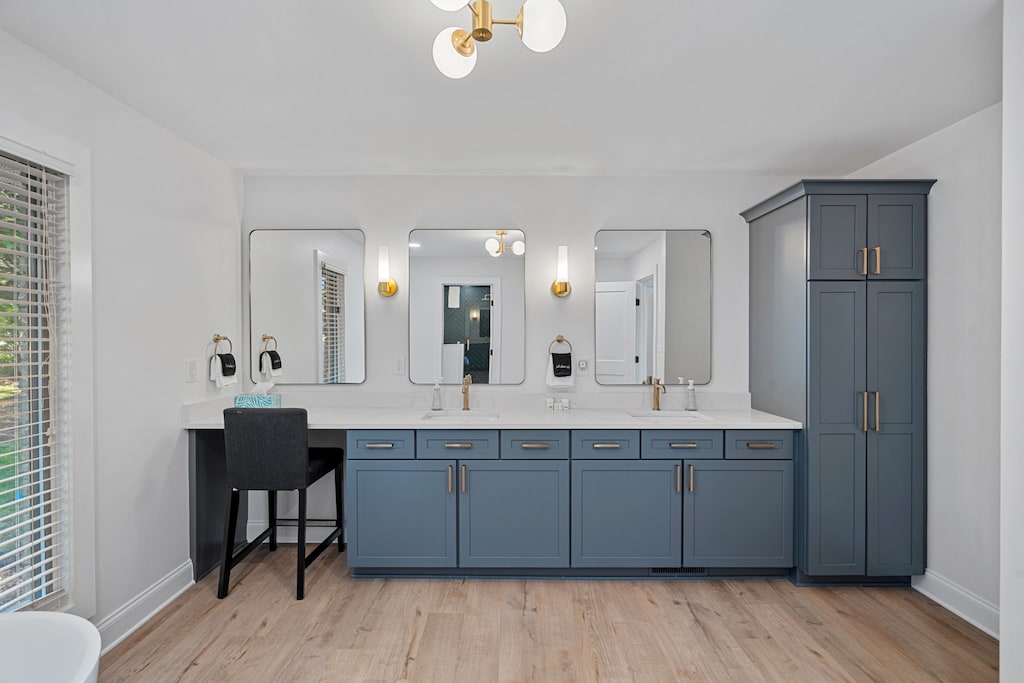 Primary bathroom with dual sinks and glass shower.