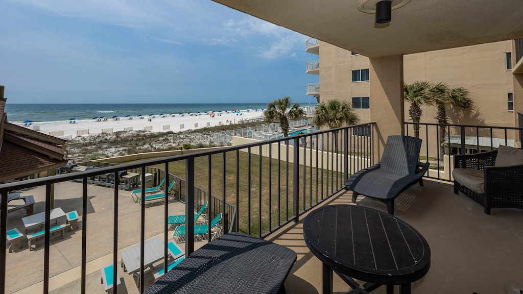 Enjoy relaxing on the balcony with comfortable seating and a beautiful view of the beach and vibrant blue waters