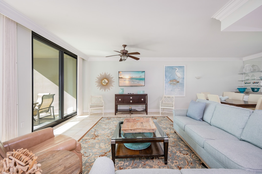 Unwind in the inviting living room with a queen sofa sleeper, feeling the warmth of the sun from the balcony
