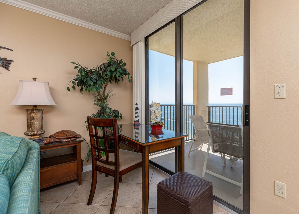A cozy corner features a wooden desk and chair with a view of the beach, the perfect workspace with complimentary Wifi