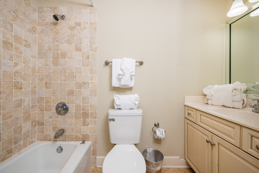 Refresh in this guest bath featuring a relaxing tub/shower, stylish tile, and neatly arranged fluffy towels for your comfort