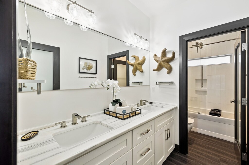 Step into your spa-like bathroom with dual vanities, marble countertops, and charming coastal decor that makes your daily routine feel luxurious.