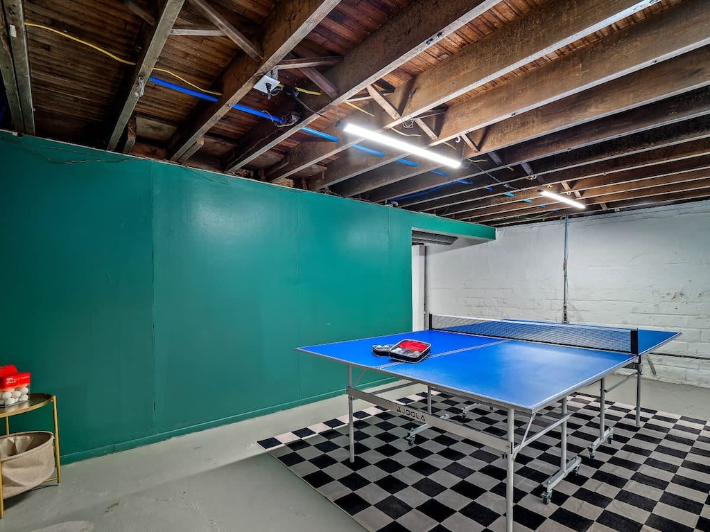Game room w/ ping pong table & bold green walls for lively indoor fun