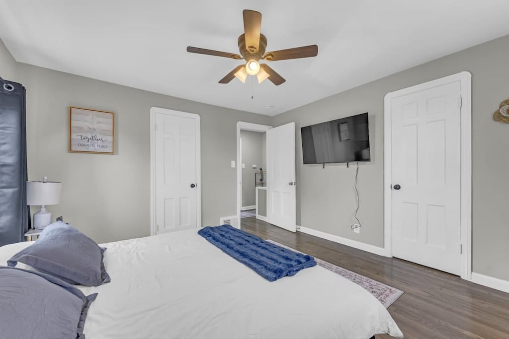 - Bedroom with flat screen TV and ceiling fan   - Cozy decor and soft linens for restful nights   - Multiple closets provide organized storage space 