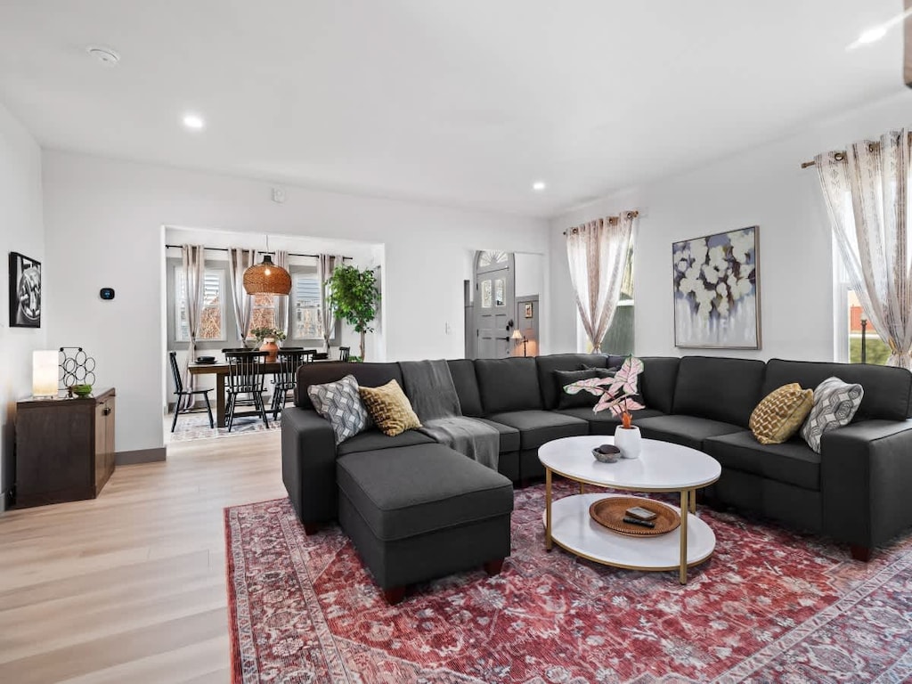 - Spacious living room with sectional sofa and bold rug   - Open layout flows into dining space with natural light   - Perfect gathering spot for groups and family stays  