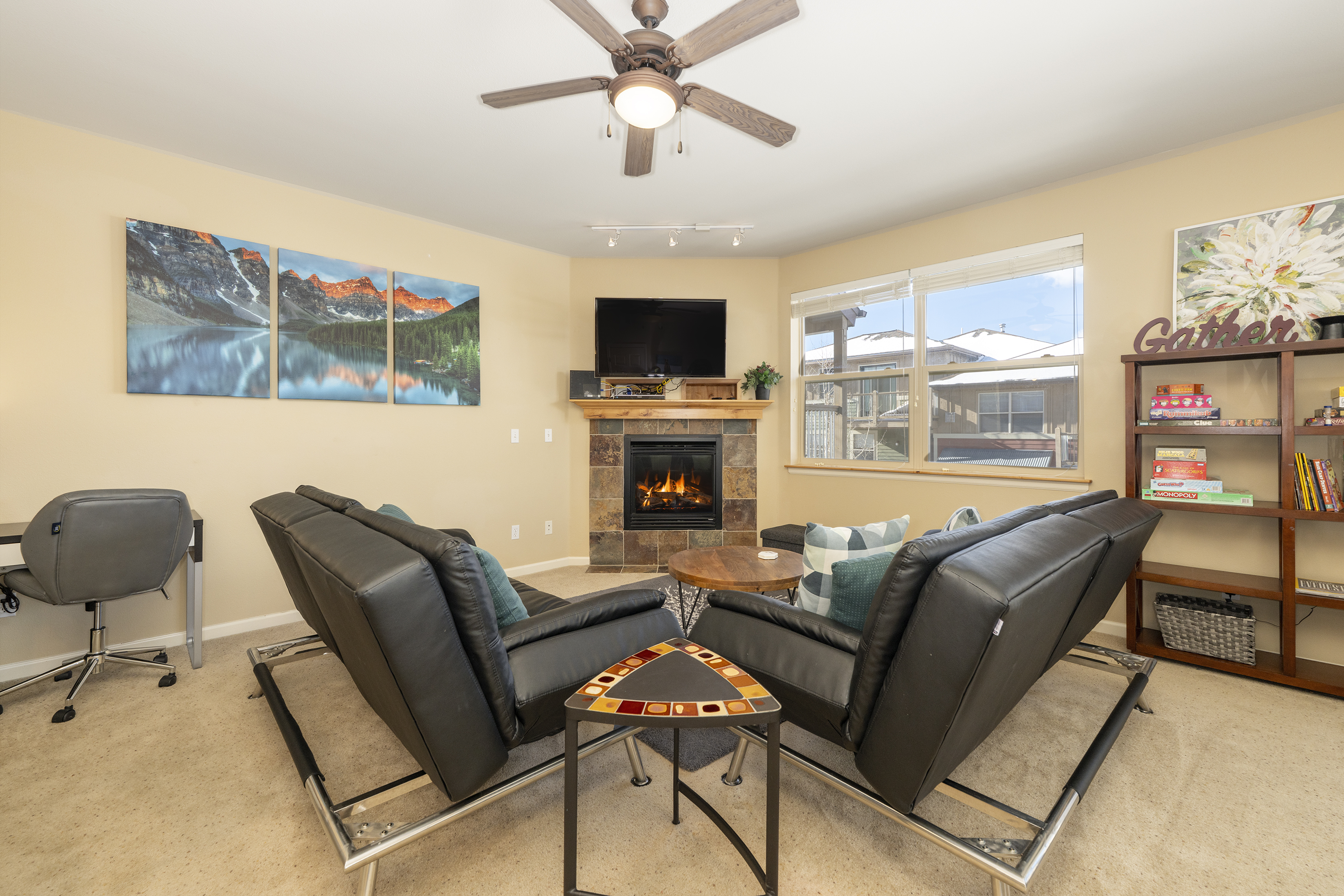 Settle into your cozy living room where leather seating surrounds a warm fireplace, perfect for relaxing evenings after your mountain adventures.