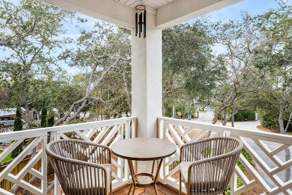 The private upstairs balcony offers a quiet spot to sip coffee and enjoy the tree-lined views.
