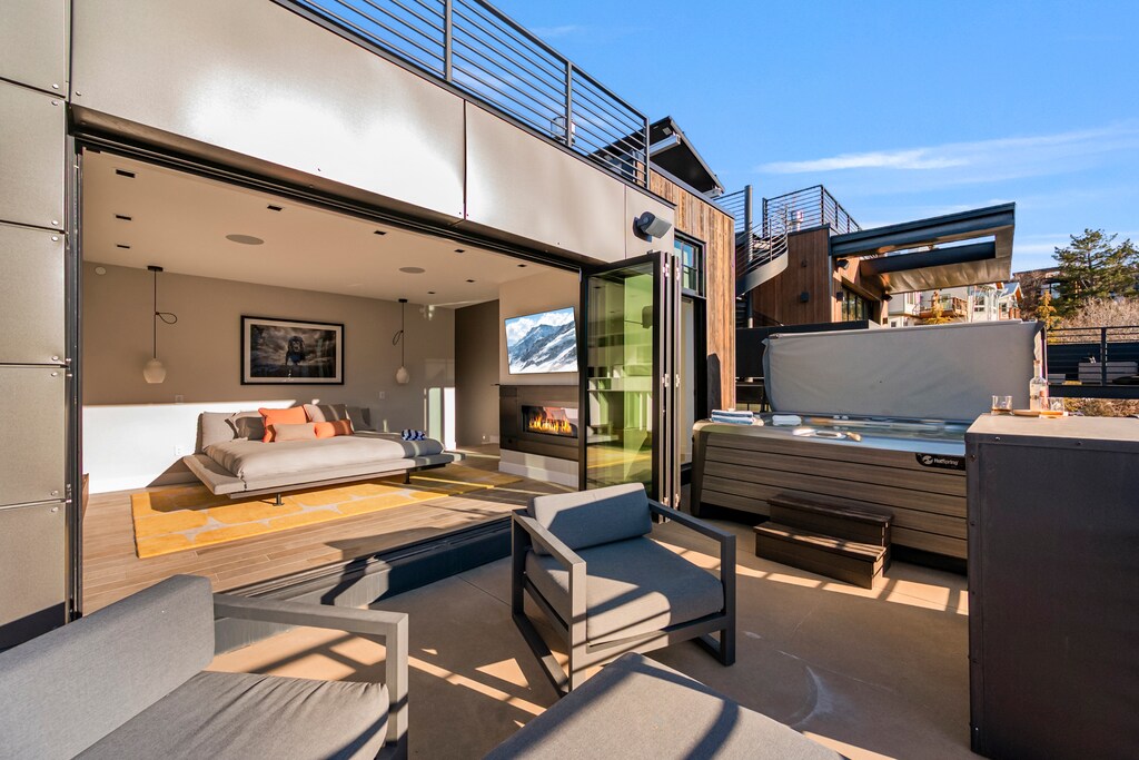 Enjoy your private hot tub on the terrace while gazing at stunning mountain views. Inside, unwind by the fireplace in your contemporary bedroom.