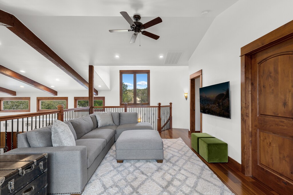Unwind in your spacious loft lounge with plush sectional seating, vaulted ceilings, and scenic mountain views through oversized windows.