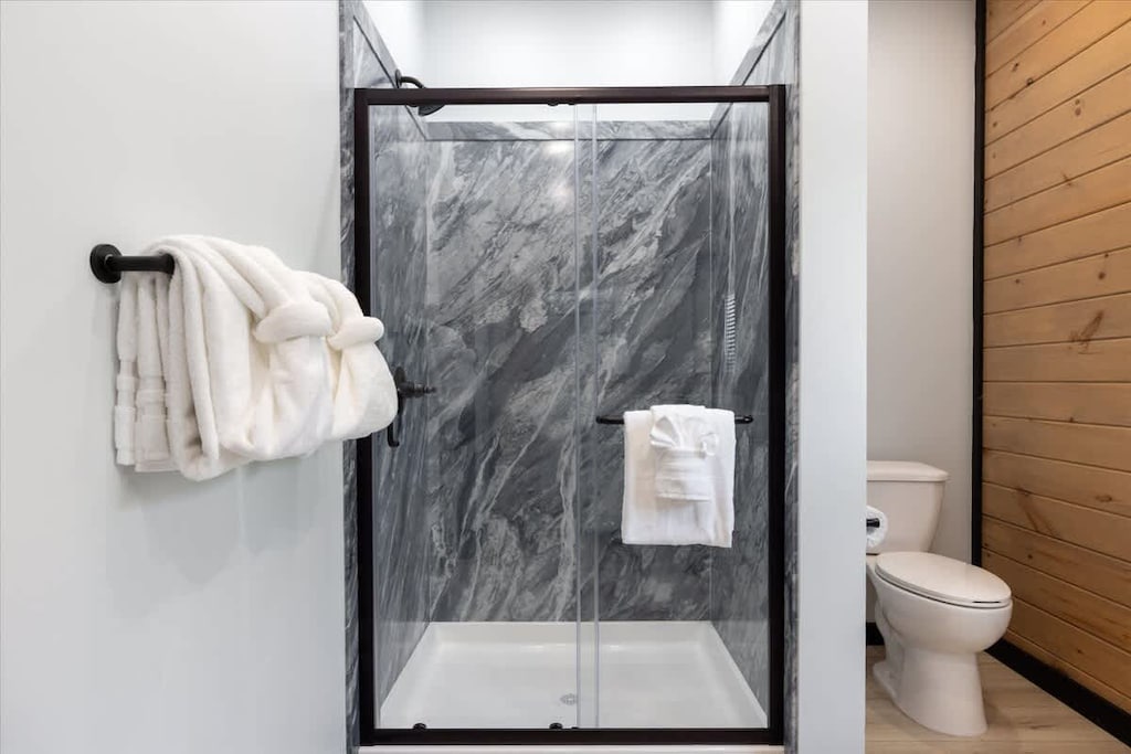 Spa-Like Retreat: Indulge in a modern glass shower and plush towels for ultimate relaxation!