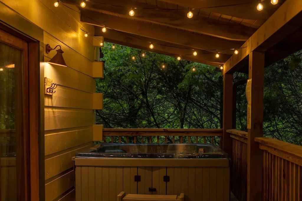 Outdoor Retreat: Unwind under twinkling lights beside your private hot tub in the serene woods!