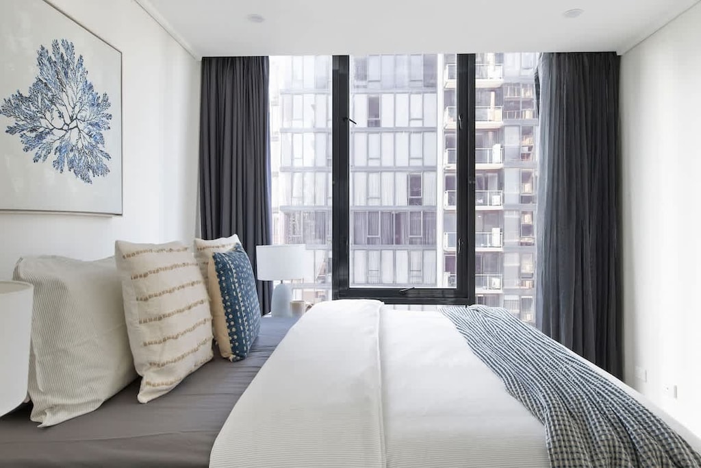 A second bedroom with a double sized bed & plush pillows.