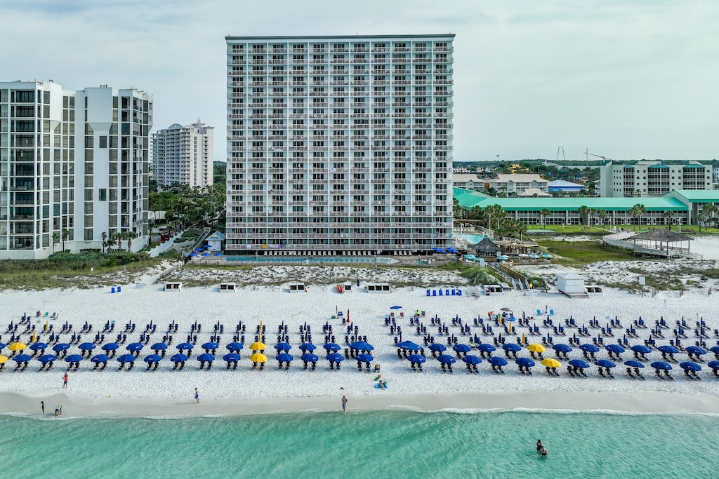 Beachfront Pelican Beach Resort offering direct access to pristine white sand and emerald Gulf waters.