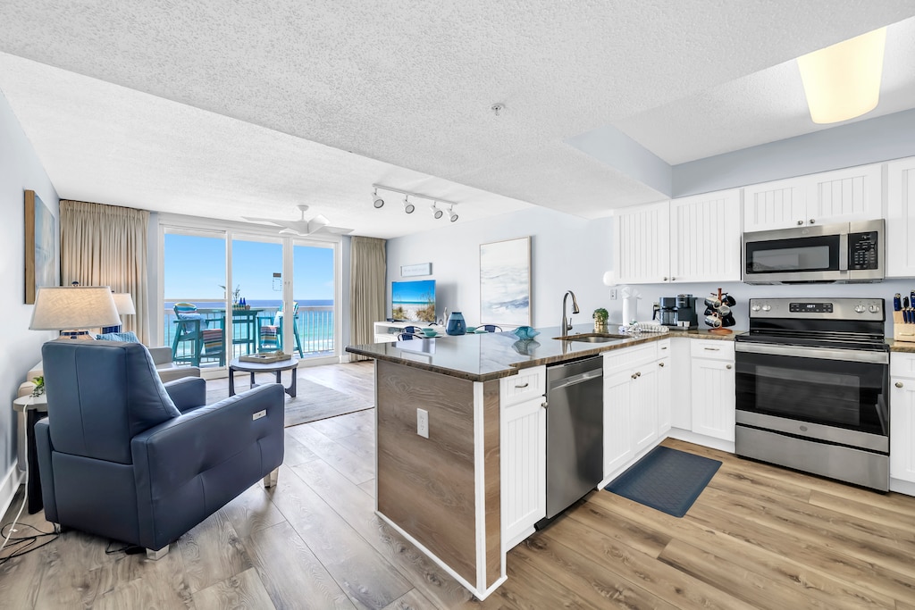 Unwind in your bright oceanfront condo where the kitchen flows into comfortable living space, all bathed in natural light from your private balcony overlooking the sea.