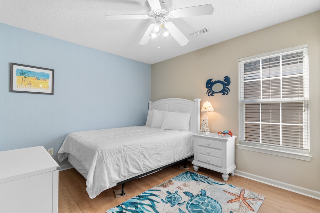 Rest in your coastal-themed bedroom where ocean blues and gentle lighting create a serene retreat after your beach adventures.