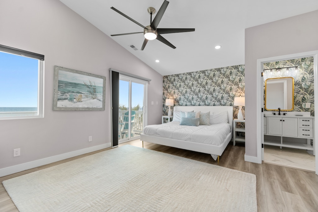 Your spacious bedroom features a coastal accent wall and views through large windows, with an ensuite bathroom for ultimate comfort.