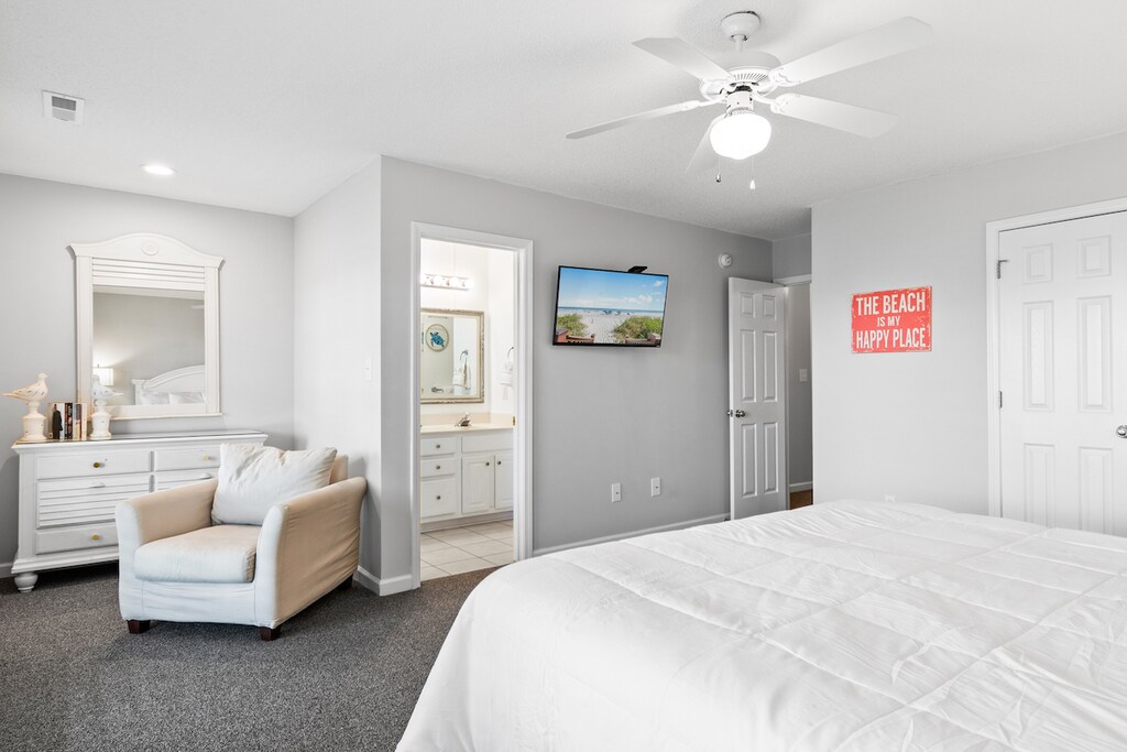 Wake up refreshed in your spacious master suite, featuring plush bedding, a cozy reading chair, and an ensuite bathroom for ultimate convenience.
