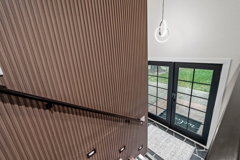 Gorgeous french front doors lead to split level entrance
