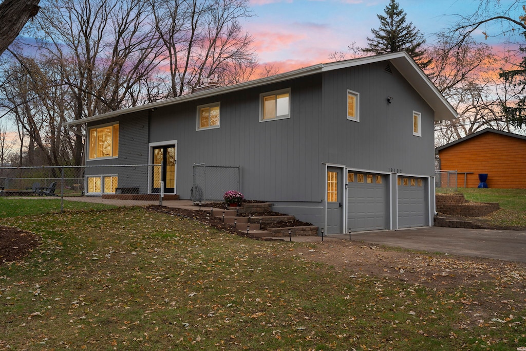 Modern split-level property situated in a peaceful wooded neighborhood during the beautiful evening twilight hours.