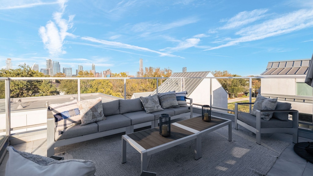 Rooftop terrace with comfortable outdoor seating and a view of the sky.