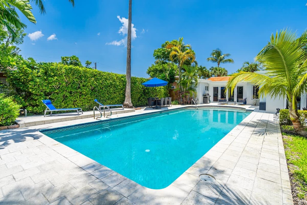 “Relax by this tropical Airbnb pool with palm trees, lounge chairs, and sunny vibes—perfect vacation rental for leisure, comfort, and unforgettable stays.”