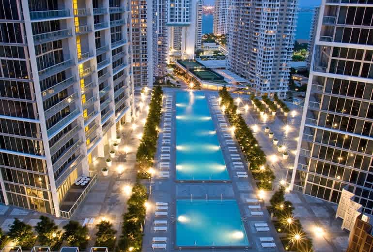 "Enjoy a vibrant city stay with illuminated pools and modern high-rise living — your perfect Airbnb vacation rental."