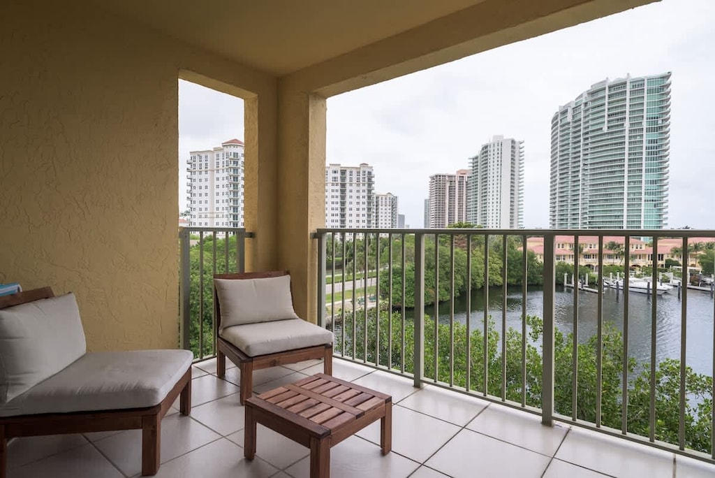 🌅 Sip coffee with skyline & water views! This vacation rental offers peaceful outdoor seating & city charm.