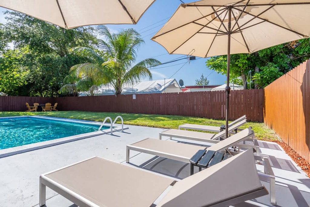 “Private pool with shaded lounge chairs—your vacation rental escape for sun and relaxation.”
