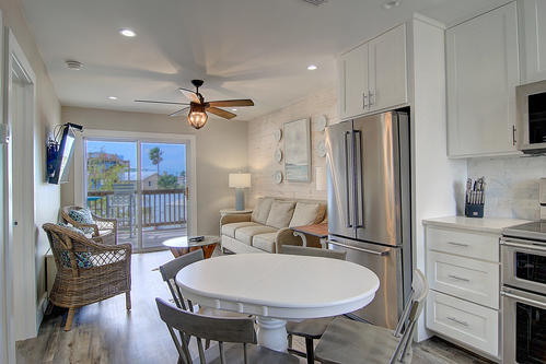 Your bright kitchen flows into a cozy living area where you can cook, dine, and unwind while enjoying views beyond.
