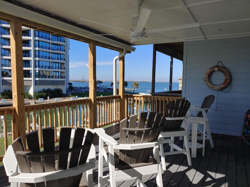 Your covered deck offers stunning water views with comfortable Adirondack chairs perfect for morning coffee or sunset relaxation.