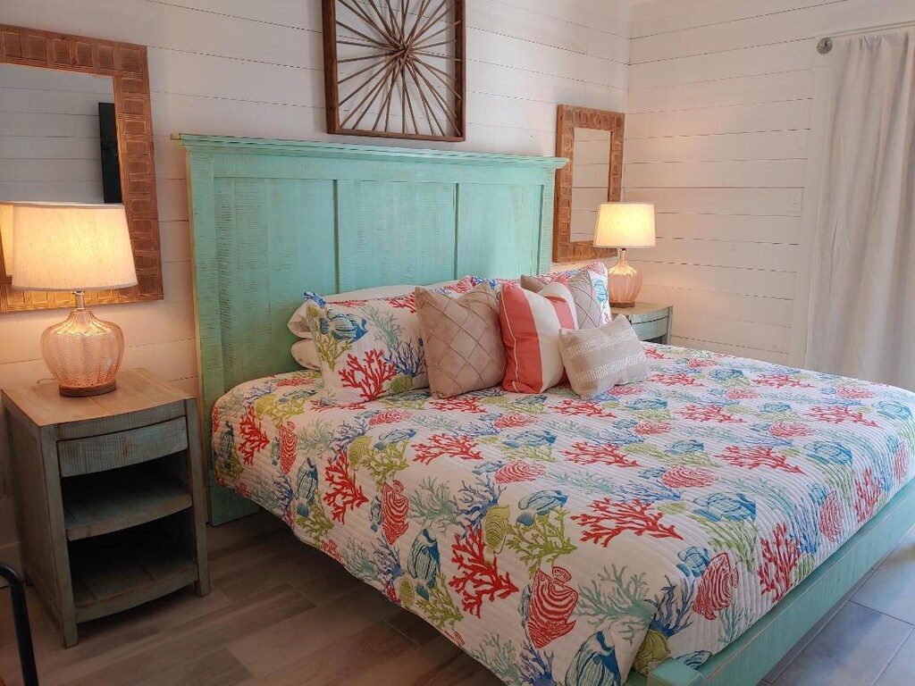 Drift into peaceful dreams surrounded by vibrant coral reef bedding and warm coastal charm in your serene bedroom retreat.