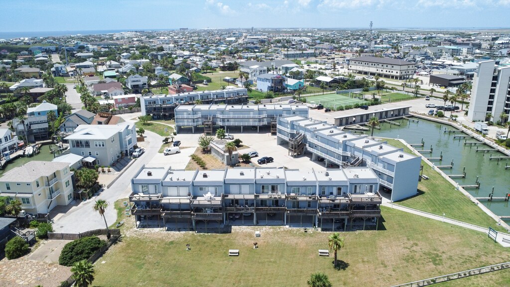 Coastal resort complex with modern architecture, waterfront access, and comprehensive amenities set within a vibrant residential community.