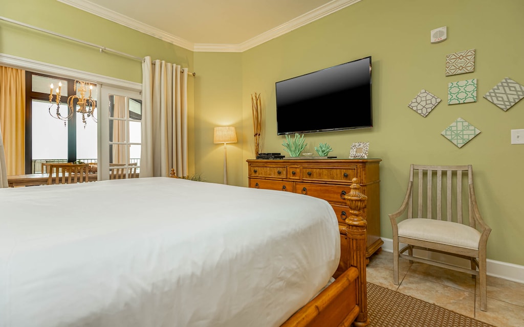 The master bedroom features soft green walls, a TV, and a lovely view of the dining area through glass doors