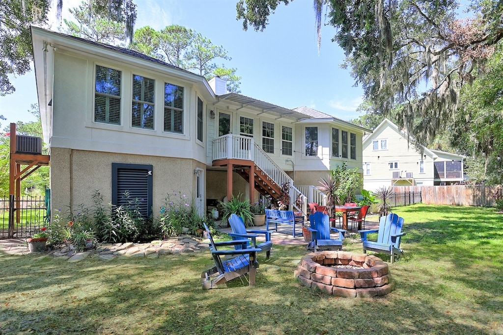 Enjoy warm nights and good company by the firepit in this spacious backyard escape.