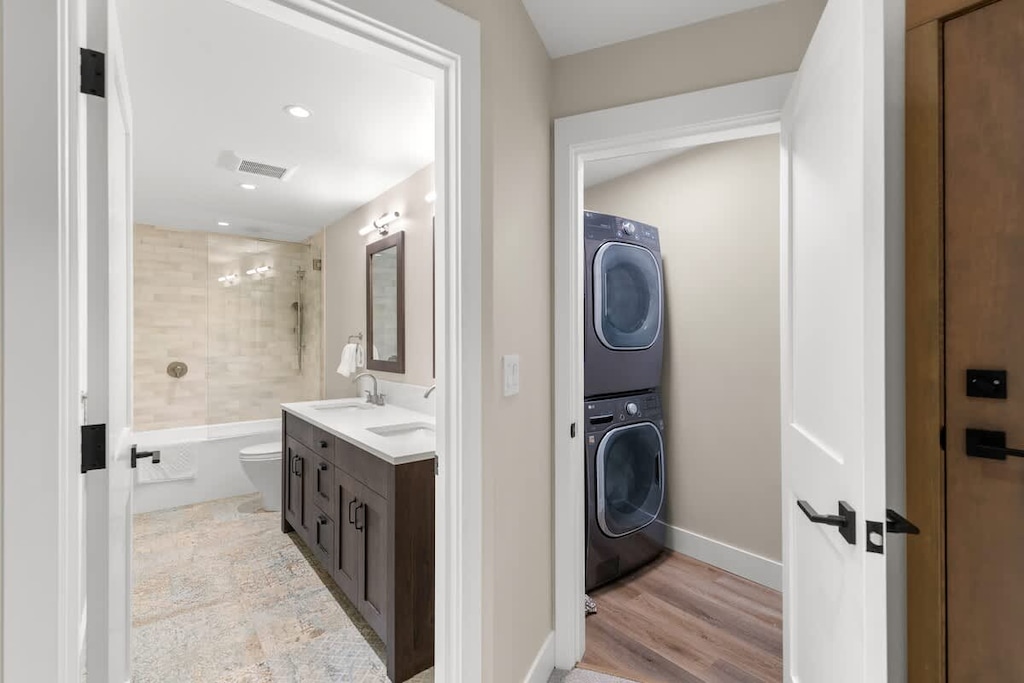 - Bright hallway view revealing bathroom and laundry access  
- Washer and dryer offer modern convenience during long stays  
- Great layout for families and extended mountain getaways  