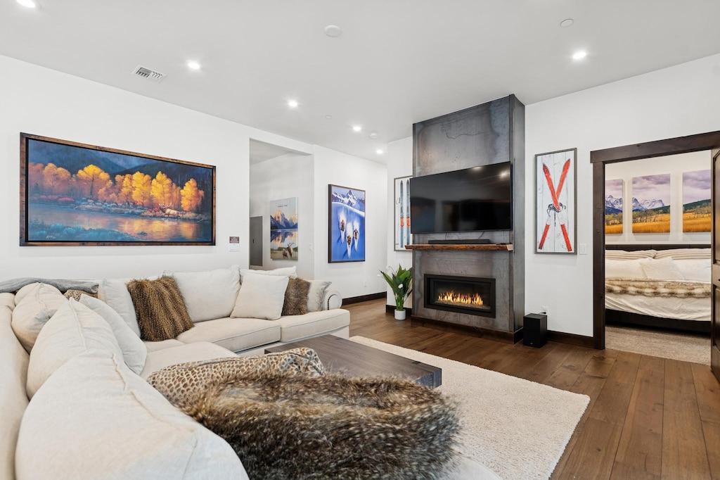 Unwind in this elegant living room where cozy seating surrounds a warm fireplace, perfect for your evening relaxation.