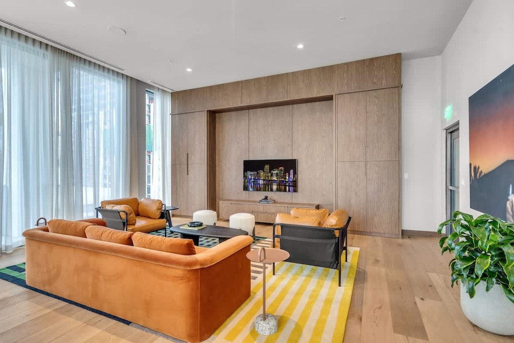 Catch the big game or your favorite show in the clubroom’s media corner, featuring a large wall-mounted TV, a velvet sofa, and leather armchairs.