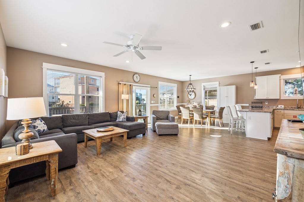 Relax in this spacious open-concept living area where your family can gather on the plush sectional while meals are prepared in the fully-equipped kitchen nearby.
