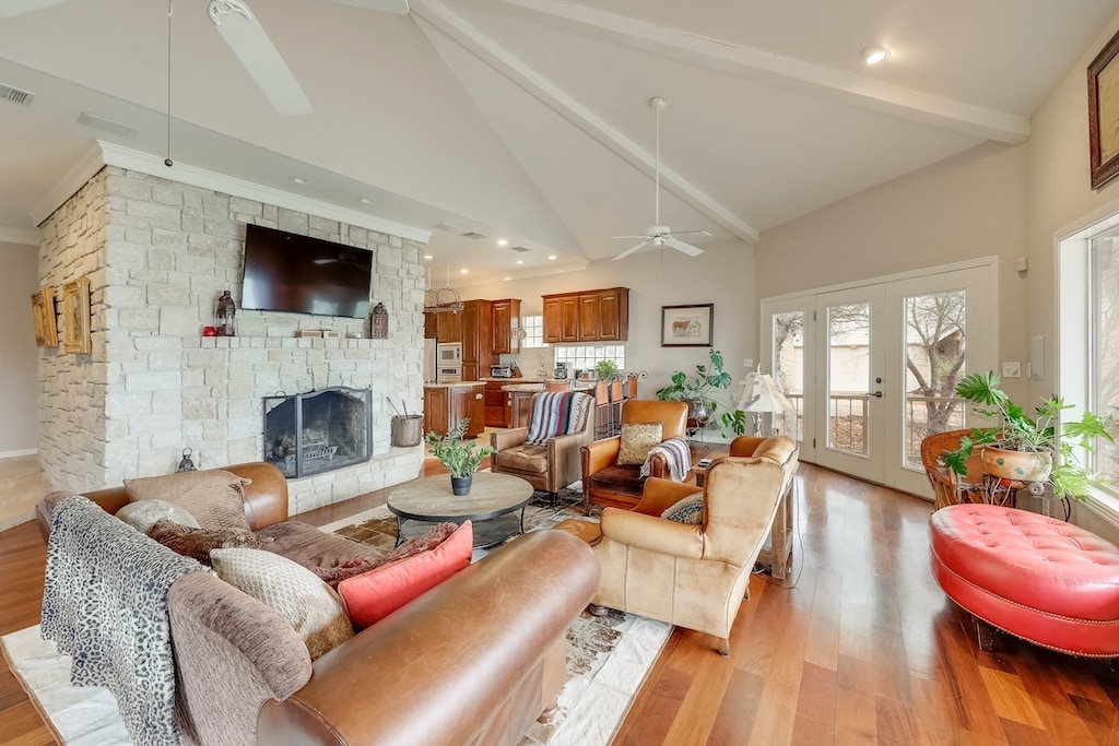 The living room boasts comfortable Texas-themed furnishings, a 70-inch flat-screen TV, and huge windows with an impressive view of the lake.