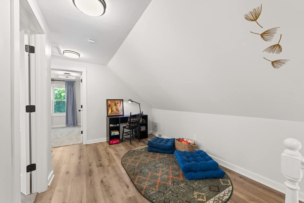 A cozy attic office space with a classic touch of elegance. The polished wooden floor complements the soothing blue, creating a serene work environment. 