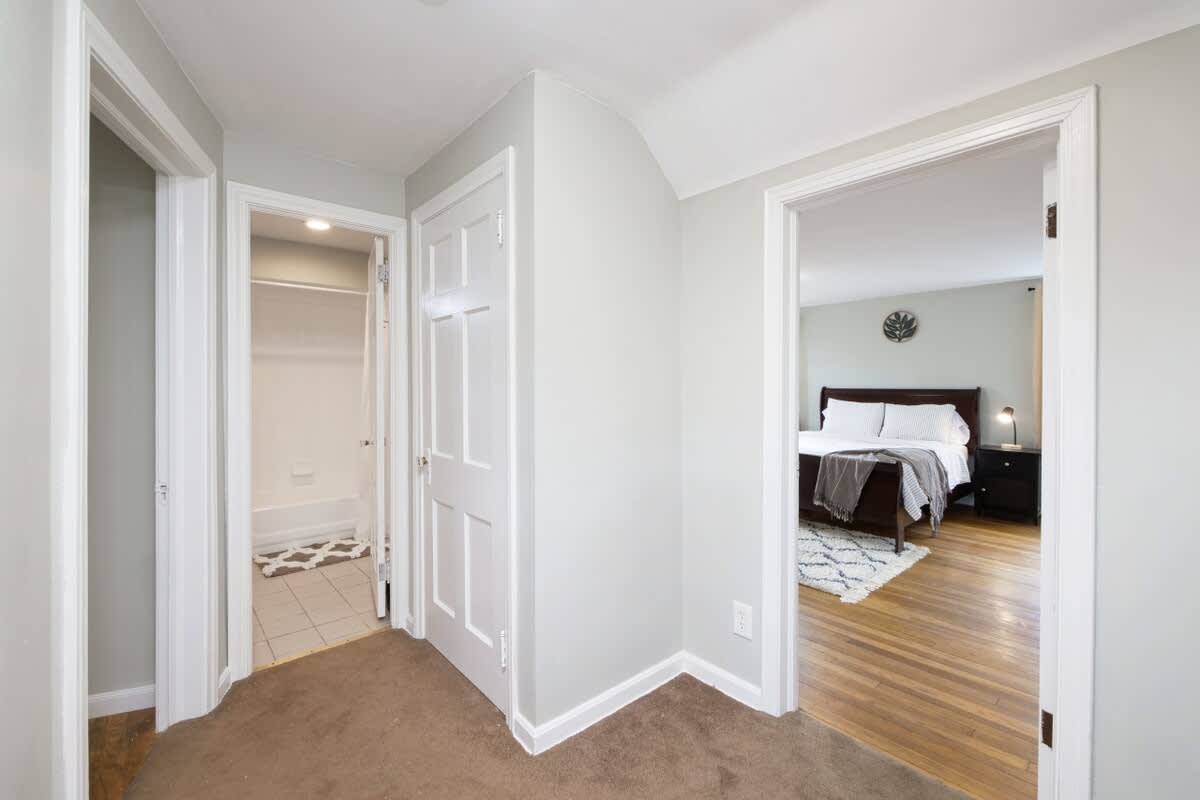 - Upstairs hallway with multiple room access points   - View into updated bathroom and cozy bedroom spaces   - Neutral walls and trim keep layout fresh and inviting  