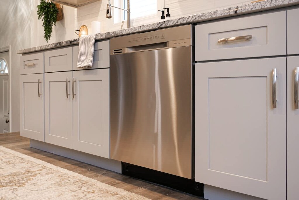 - Stainless steel dishwasher and gray cabinets   - Long granite counters for cooking and prep   - Bright modern finishes make cleanup easy  