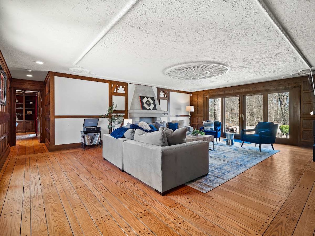 Cozy living room corner w/ fireplace, soft seating & warm wood accents for relaxed evenings.