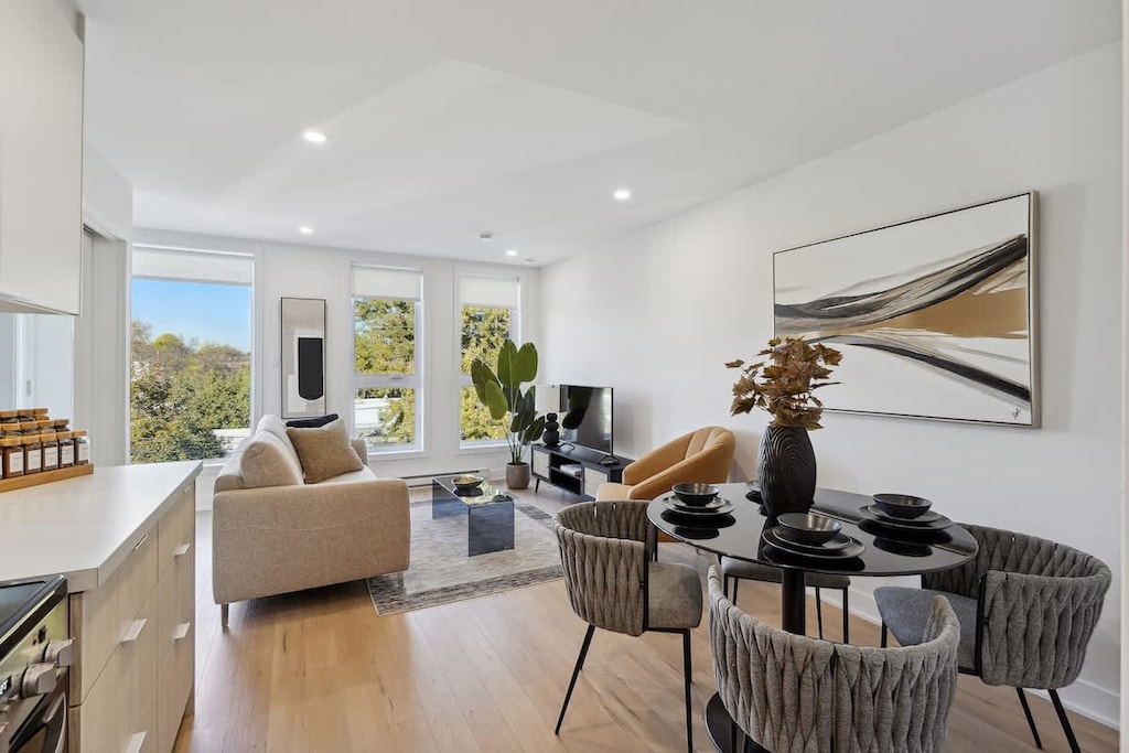 Dining area next to the living room, enhanced by stylish wall art—perfect for cozy meals and socializing.