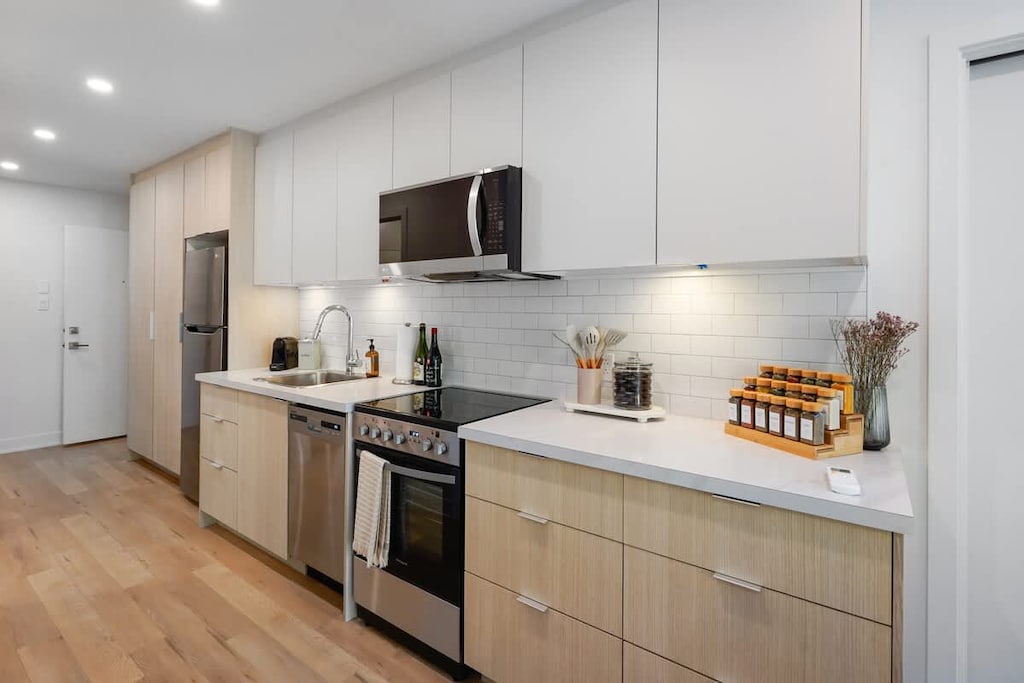 Spacious kitchen featuring a clean white and warm wood design—where style meets practicality for all your cooking needs.