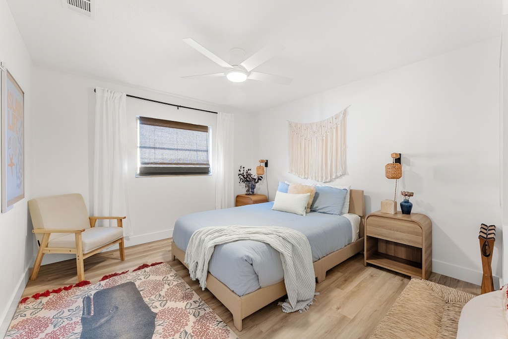 Guest bedroom features a plush queen bed
